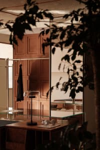Modern retail storefront featuring wooden cabinets, glass displays, and metal accents.