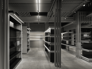 An empty storefront with industrial design elements and metal shelves.