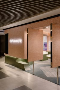 Modern terrazzo and concrete storefront entrance for a retail store.