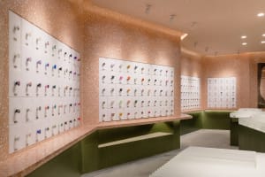 A retail store with a terrazzo display wall showcasing various colorful products.