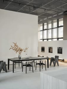 Modern commercial space with white concrete floors, glass windows, and minimalist design.