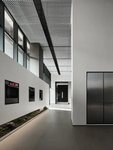 Modern residential interior with industrial design elements, featuring metal materials and a minimalist aesthetic.