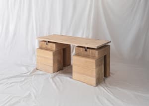 A modern wooden desk with a minimalist design and natural wood finish.