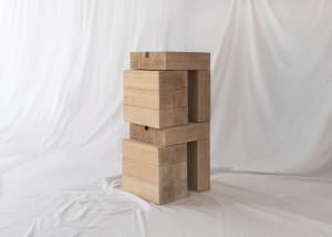 A modern wooden stool with a marble top.