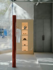 Modern retail store display featuring neutral-colored materials and lighting.