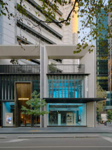 Modern retail storefront featuring glass and concrete materials.
