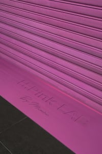 A minimalistic design featuring a vibrant purple gradient with the text 'Pink Lab'