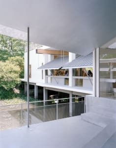 A modern architectural structure with a metal roof.