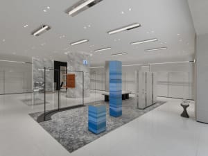 Modern retail storefront featuring glass, marble, and metal materials