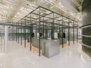 An industrial-style retail clothing shop with a steel frame and corrugated metal walls.