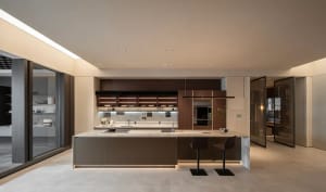 Modern kitchen featuring wooden cabinets and marble countertops