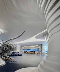 A modern retail space featuring concrete structures and artistic elements.