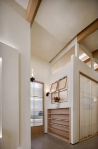 Minimalist interior design featuring wooden shelves and soft lighting.