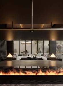 A modern living room featuring large glass walls and a cozy seating arrangement with white sofas and coffee tables.