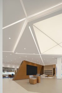 Modern lobby interior featuring concrete walls and minimalist furniture.