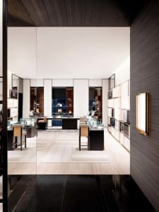 Modern retail shop with glass display cases, metal furniture, and wooden flooring.