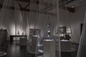 An interior design exhibition featuring a curtain made of thin strings hanging from the ceiling.