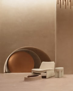 A minimalist, modern interior space featuring textured taupe textiles and abstract art, with a round geometric element in the