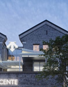 A contemporary brick building with large glass windows and a modern design.