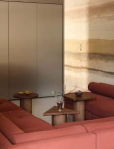 Modern sofa in a minimalist living room with a fabric upholstery and wooden furniture.