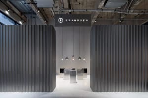 Industrial-style commercial interior with metallic walls and hanging lamps.