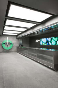Modern retail storefront with glass counters and digital display.