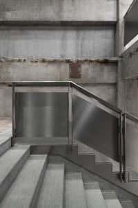 Modern staircase with concrete steps and walls.