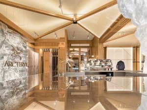 A modern retail store with a wooden interior and a centrally located counter.