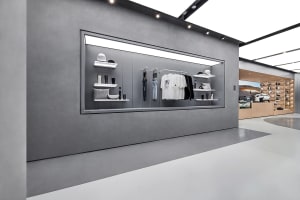 Modern retail storefront featuring minimalist design with concrete walls and sleek, urban aesthetics.