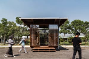 A modern library constructed with wooden materials and featuring a clear glass wall.