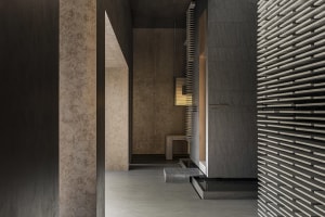 A modern corridor featuring concrete walls and lighting fixtures.
