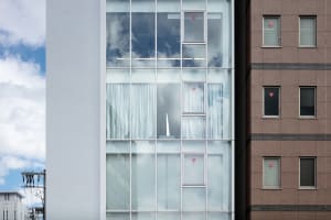 Reflections of a modern office building with a glass facade on a clear day.