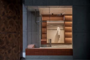 A modern clothing store display featuring wooden accents, showcasing contemporary retail design.