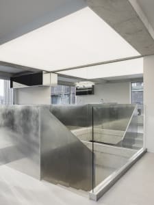 An interior office space featuring modern, minimalist design with concrete elements.
