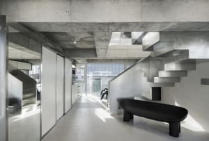 Minimalist interior design featuring concrete and steel materials.