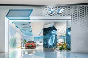 Automobile dealership storefront with a modern glass design and BMW i logo.