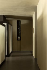 A modern corridor with concrete floors and a minimalist design.