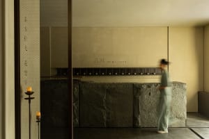 Modern spa interior featuring natural stone walls and flooring, minimalist design.