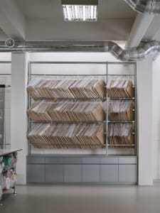 Large industrial storage rack filled with cardboard boxes in a warehouse setting.