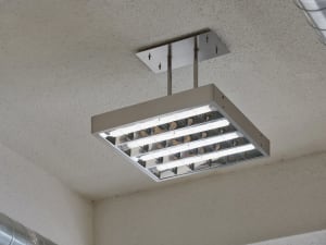 A modern ceiling light fixture with industrial cords.