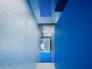 A modern interior design featuring metallic finishes and blue color scheme.