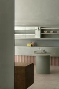 A modern retail store featuring minimalist design with concrete and wooden finishes.
