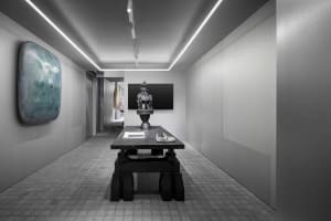Modern showroom featuring industrial design elements with concrete and metal finishes.