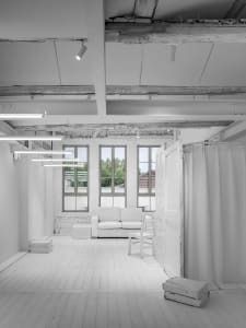 White minimalist interior with modern furniture and clean lines.