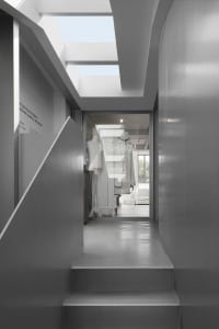 Modern minimalist interiors featuring large glass elements and sleek design.