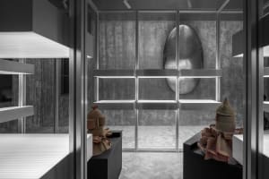 Minimalist interior with concrete walls, white lighting, and modern decor.