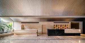 A modern hotel reception desk featuring marble and wood materials.