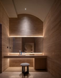A luxurious marble bathroom with ambient lighting and minimalist design.