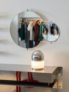 Modern retail shop interior with minimalist design and metallic lighting fixture