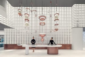 A minimalist retail space featuring white walls, glass and metal fixtures, and hanging glass floral displays.